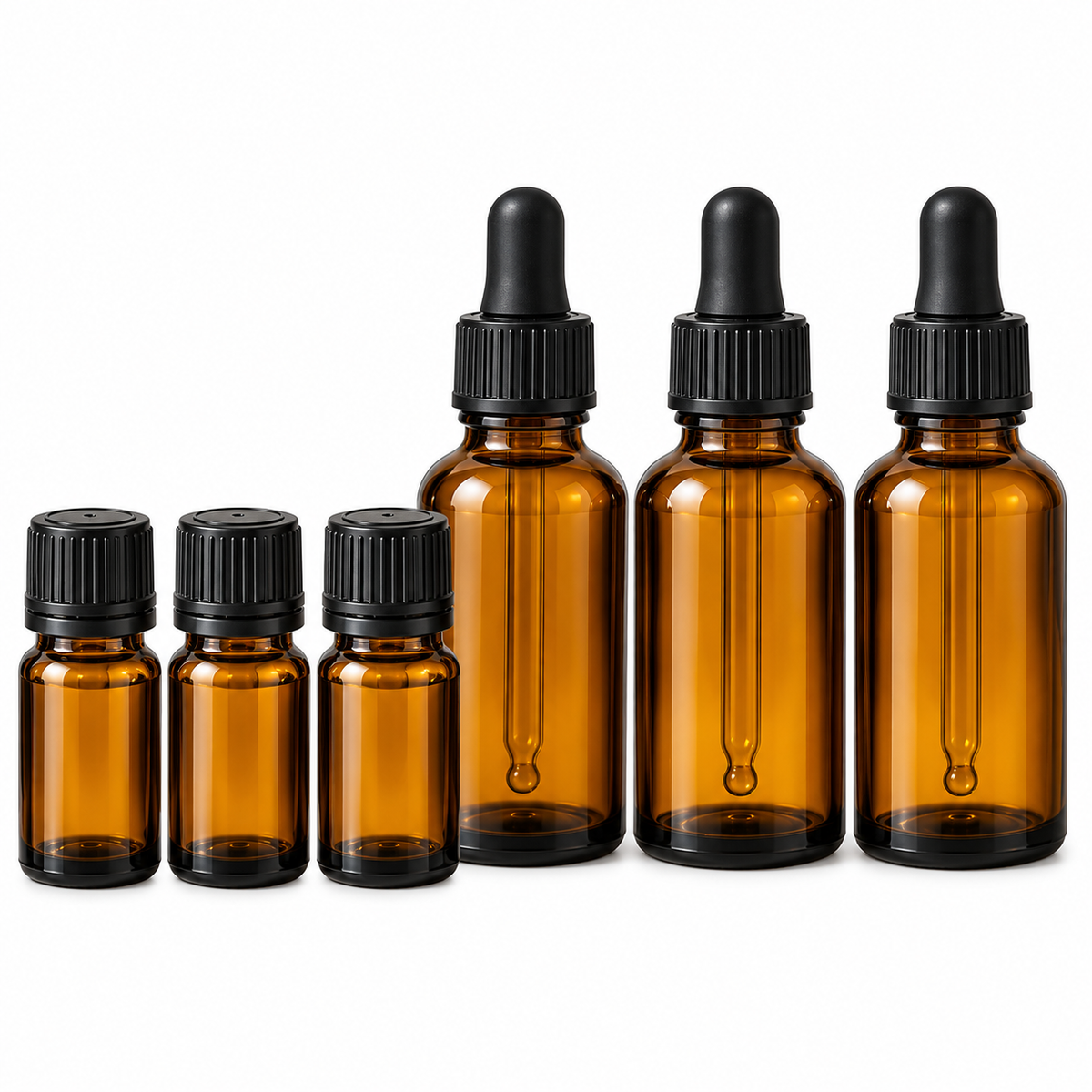 Six amber glass dropper bottles of different sizes with black rubber droppers and black ribbed caps, arranged by size on a white background.