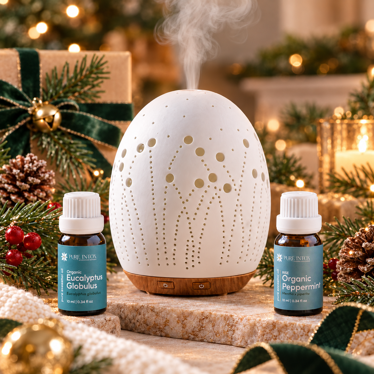Pure Intox Fresh Start aromatherapy gift set with Meadow Ceramic Diffuser, Organic Eucalyptus Globulus and Organic Peppermint essential oils in a festive holiday setting.