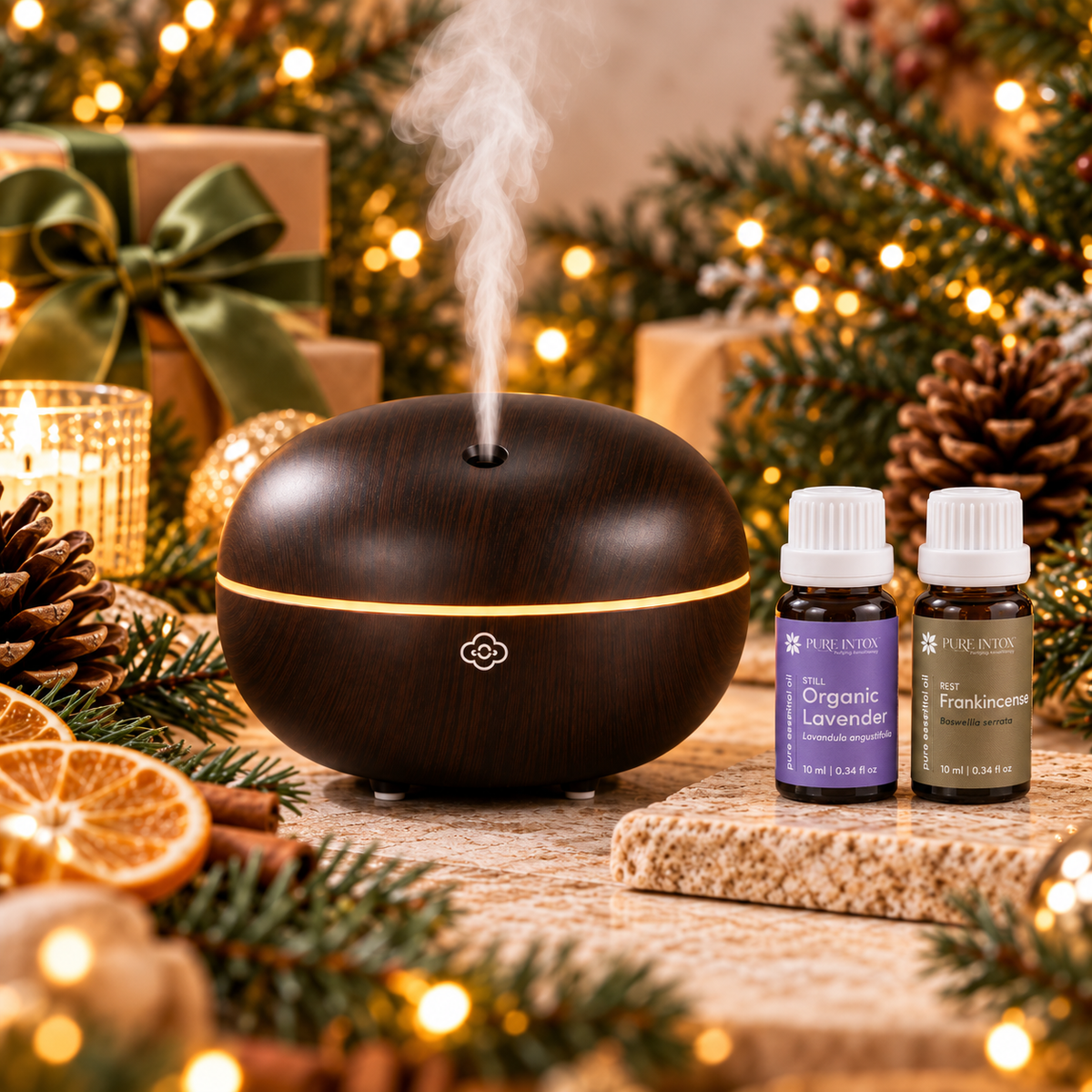 Pure Intox Quiet Evening aromatherapy gift set with Macaron Dark Wood Scentilizer, Organic Lavender and Frankincense Serrata essential oils in a warm holiday setting.
