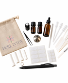 A  Blending  kit by Pure Intox, featuring an amber glass bottle with a dropper, two small amber bottles, a beige canvas drawstring bag with the brand logo, tweezers, white plastic tubes, adhesive labels, a black pen, and other accessories, all arranged on a clean white background.