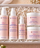 A boxed skincare set from Pure Intox, featuring five products in a white gift box filled with white crinkle paper. The set includes Gentle Botanical Cleanser, Hydrating Vitamin Essence, Daily Radiant Beauty Oil, Hydrating Cream, and Moisturizing Recovery Cream, all in soft pink packaging with white caps.