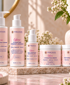 A set of five Pure Intox skincare products arranged on a marble tray with a spa-like background. The products include cleanser, hydrating ferment essence, daily resistance moisturizer, hydrating cream, and natural recovery cream in soft pink packaging with white text and pump/bottle tops.