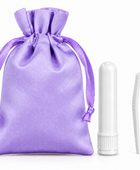 A lavender purple satin drawstring pouch shown next to a white plastic tube and a white plastic tweezers tool on a clean white background.